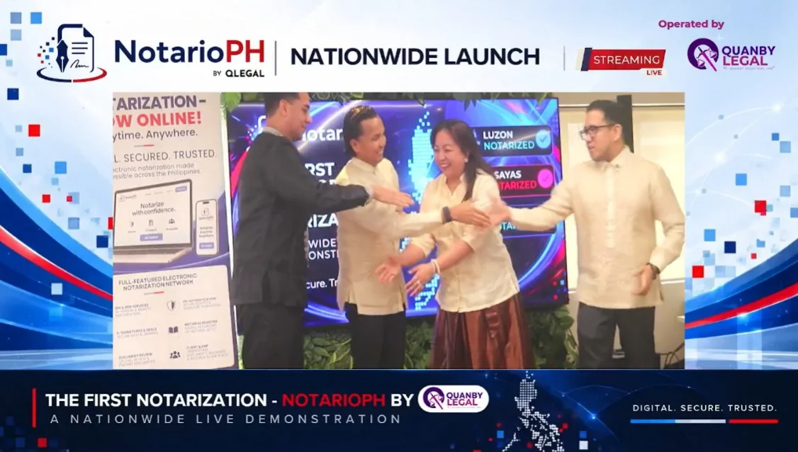 Frame from the NotarioPH Nationwide Launch livestream showing four participants joining hands on stage under the banner The First Notarization, a nationwide live demonstration